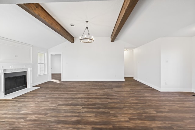 unfurnished living room with vaulted ceiling with beams, a premium fireplace, dark wood-type flooring, and an inviting chandelier