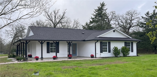 view of front of home with a porch and a front yard