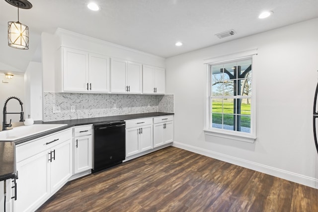 kitchen featuring decorative backsplash, sink, decorative light fixtures, black dishwasher, and white cabinetry