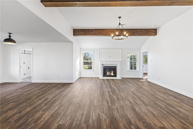 unfurnished living room featuring vaulted ceiling with beams, a premium fireplace, dark hardwood / wood-style flooring, and an inviting chandelier