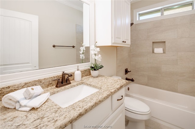 full bathroom with toilet, vanity, tiled shower / bath combo, and ornamental molding