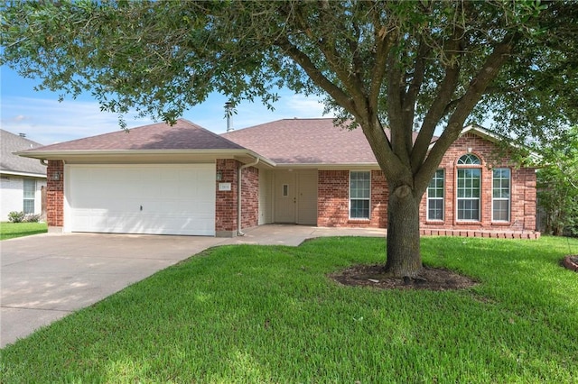 ranch-style home featuring brick siding, concrete driveway, a garage, a front lawn, and a shingled roof