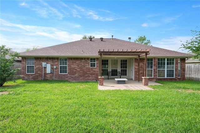 rear view of property with a patio, a pergola, a lawn, and a fenced backyard