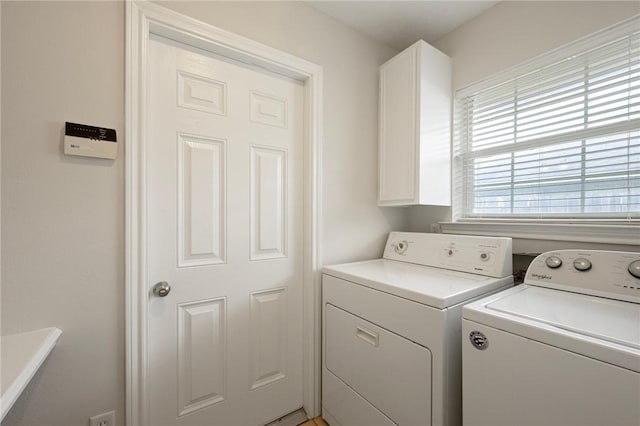 laundry area featuring washing machine and dryer and cabinet space