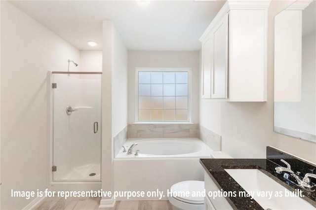 full bathroom featuring hardwood / wood-style flooring, vanity, separate shower and tub, and toilet