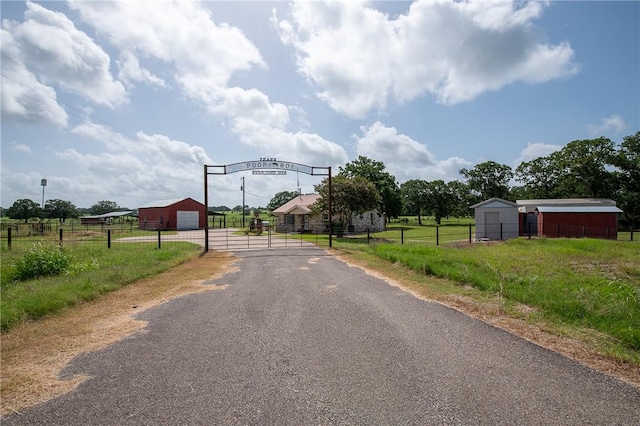 4454 Fm 60 E, Somerville, TX 77879 - view of asphalt driveway with a gated entry, a gate, and a rural view