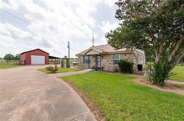 4454 Fm 60 E, Somerville, TX 77879 - view of front facade with stone siding, driveway, an outbuilding, a garage, and a metal roof