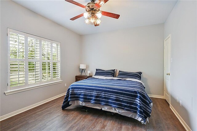 bedroom featuring dark hardwood / wood-style flooring and ceiling fan