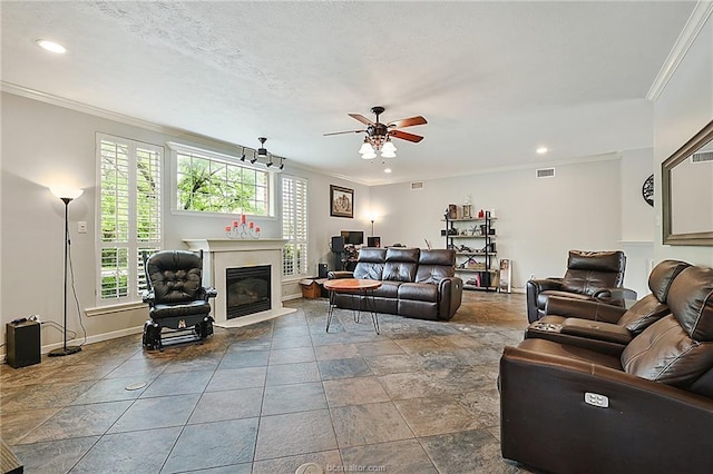 living room with ceiling fan and ornamental molding