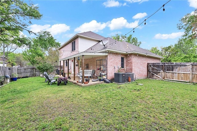 rear view of house featuring a patio area and a yard