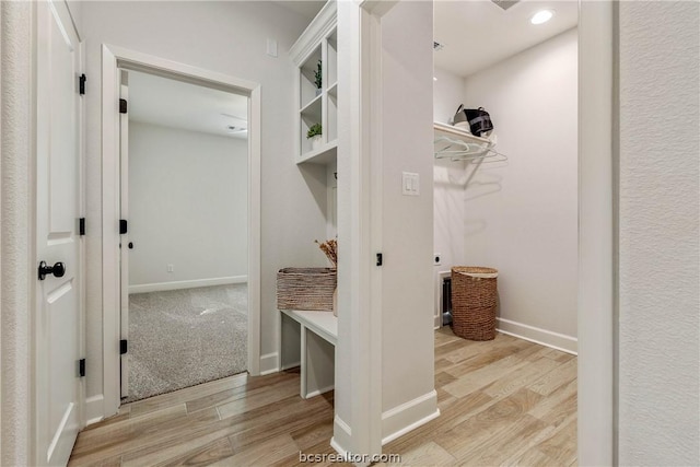 mudroom with light hardwood / wood-style floors