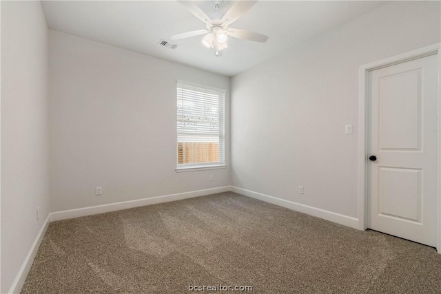 carpeted spare room with ceiling fan