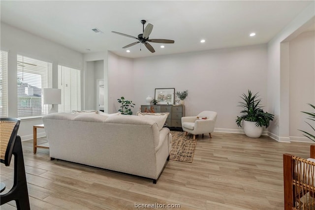 living room with light wood-type flooring and ceiling fan