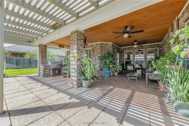 view of patio featuring an outdoor kitchen, ceiling fan, and a pergola