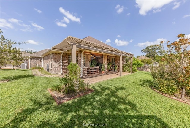 back of house with a pergola, ceiling fan, central AC, a patio area, and a lawn