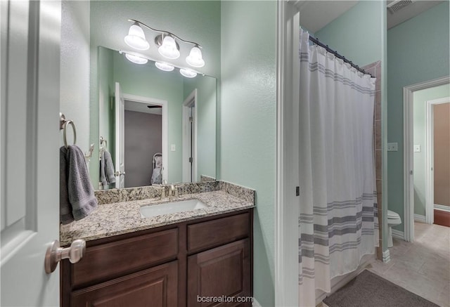 bathroom featuring tile patterned floors, vanity, toilet, and a shower with curtain