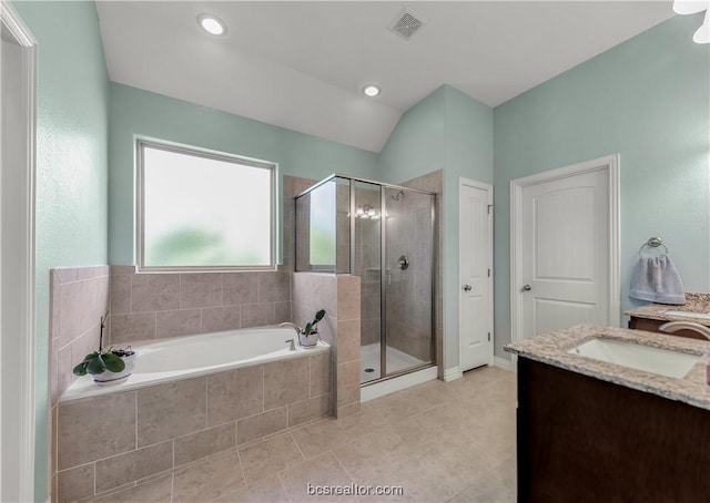 bathroom with plus walk in shower, vanity, tile patterned floors, and vaulted ceiling