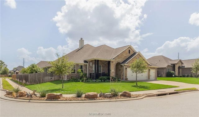 view of front of house featuring a front yard and a garage