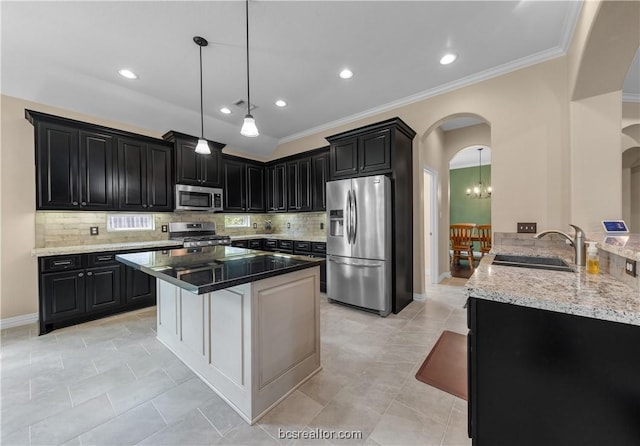 kitchen featuring kitchen peninsula, a kitchen bar, stainless steel appliances, sink, and dark stone countertops