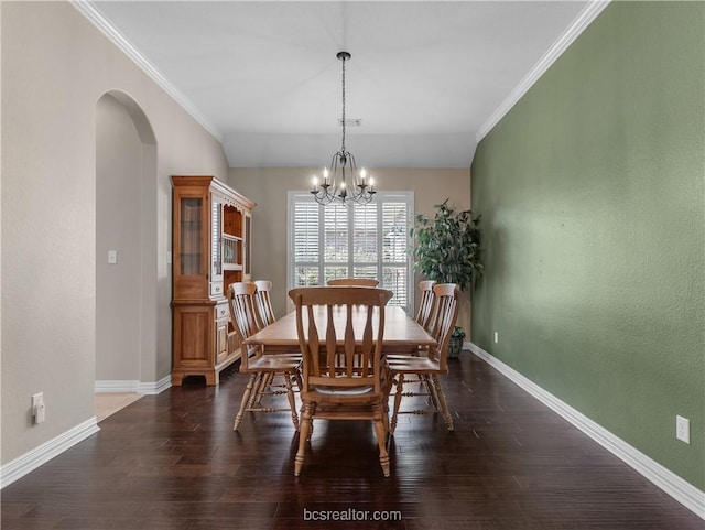 dining area featuring dark hardwood / wood-style flooring, a chandelier, and ornamental molding