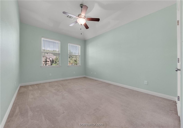 unfurnished room with ceiling fan and light carpet