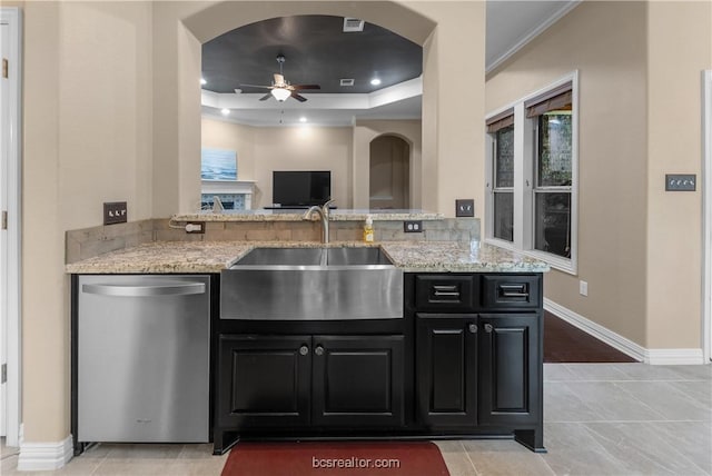 kitchen featuring ceiling fan, sink, light stone counters, stainless steel dishwasher, and kitchen peninsula