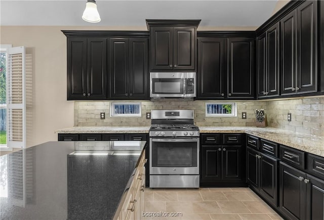 kitchen featuring decorative backsplash, stainless steel appliances, and a healthy amount of sunlight