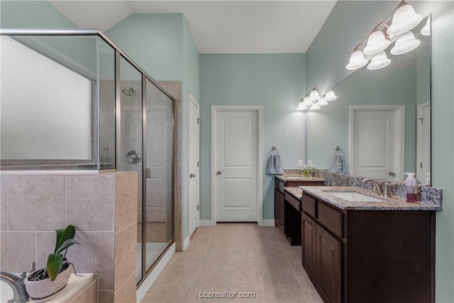 bathroom with tile patterned flooring, vanity, vaulted ceiling, and a shower with door