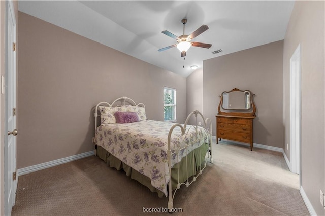 carpeted bedroom with ceiling fan and vaulted ceiling