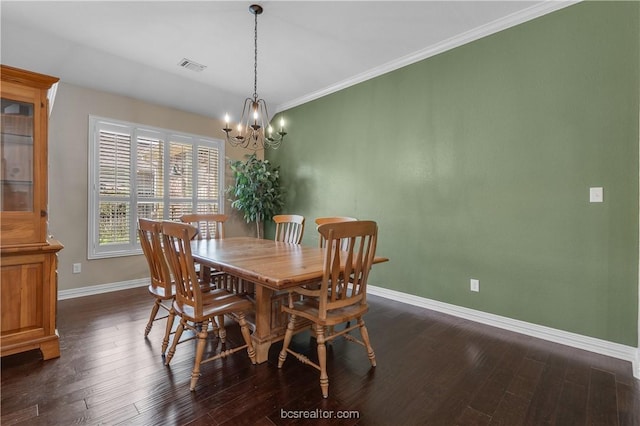 dining space with crown molding, a chandelier, and dark hardwood / wood-style floors