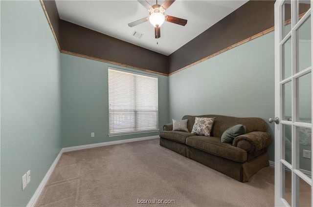 living area featuring carpet, ceiling fan, and french doors