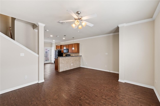 unfurnished living room featuring dark hardwood / wood-style floors, ceiling fan, ornamental molding, and decorative columns