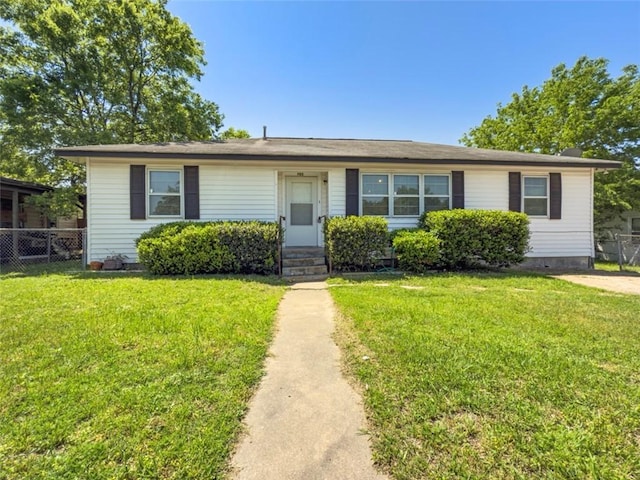 view of front of home with fence, a front yard, and entry steps