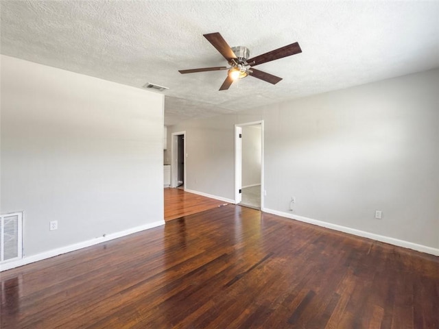 spare room with visible vents, ceiling fan, wood finished floors, and baseboards