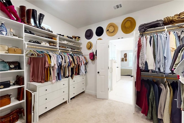 walk in closet featuring visible vents and carpet floors