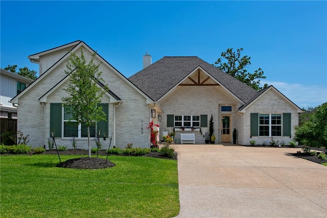 ranch-style house with a chimney, brick siding, and a front lawn