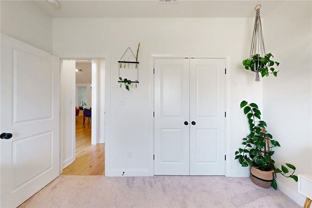 bedroom with a closet, visible vents, baseboards, and carpet floors