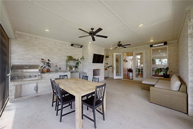 dining space with exterior fireplace, french doors, ceiling fan, and recessed lighting