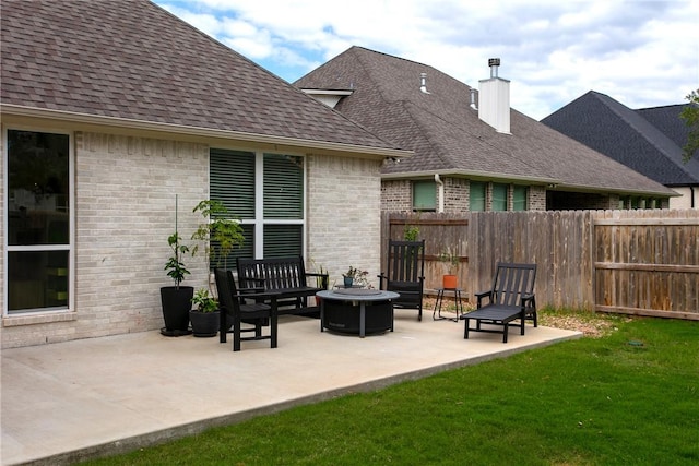 exterior space with an outdoor fire pit and fence