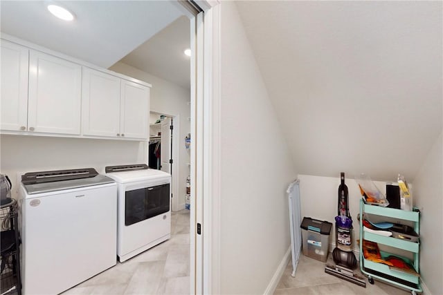 clothes washing area featuring recessed lighting, baseboards, light tile patterned floors, washing machine and clothes dryer, and cabinet space