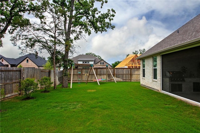 view of yard featuring a fenced backyard and a playground