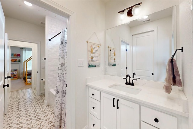 full bath featuring vanity, baseboards, visible vents, and tile patterned floors