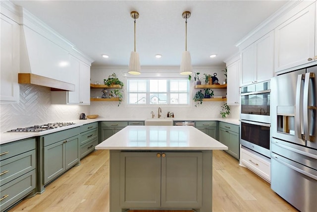 kitchen featuring open shelves, green cabinetry, and stainless steel appliances