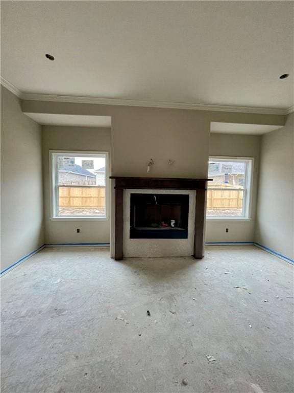 unfurnished living room with crown molding