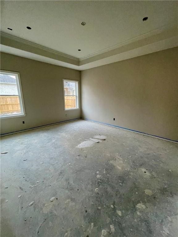 spare room featuring crown molding and a tray ceiling