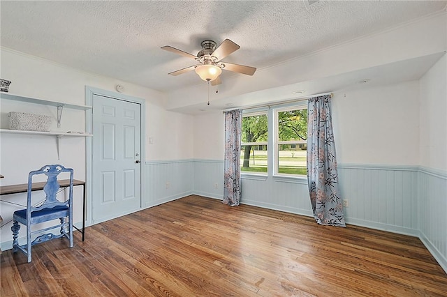 809 Coulter Dr S, Bryan, TX 77803 - spare room with wood-type flooring, a textured ceiling, and ceiling fan