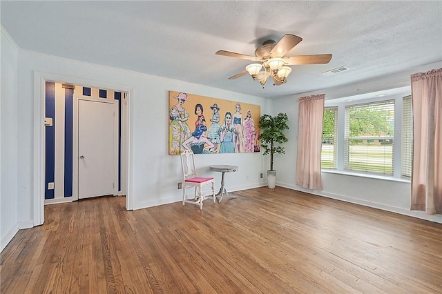 809 Coulter Dr S, Bryan, TX 77803 - spare room featuring a textured ceiling, hardwood / wood-style flooring, and ceiling fan