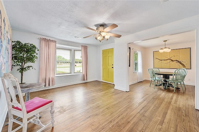 809 Coulter Dr S, Bryan, TX 77803 - living area with ceiling fan, wood-type flooring, and a textured ceiling