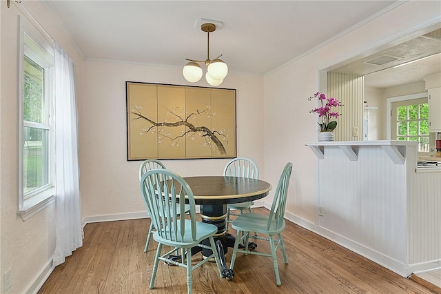 809 Coulter Dr S, Bryan, TX 77803 - dining space with hardwood / wood-style floors, crown molding, and a chandelier
