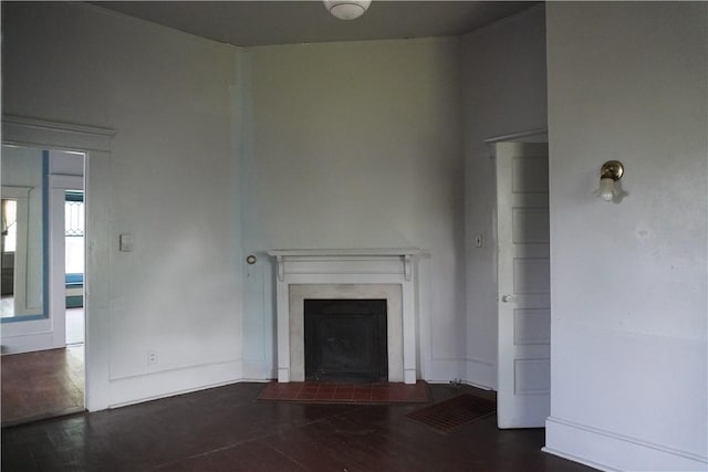 608 W 27th St, Bryan, TX 77803 - unfurnished living room with wood finished floors, a fireplace with flush hearth, and baseboards